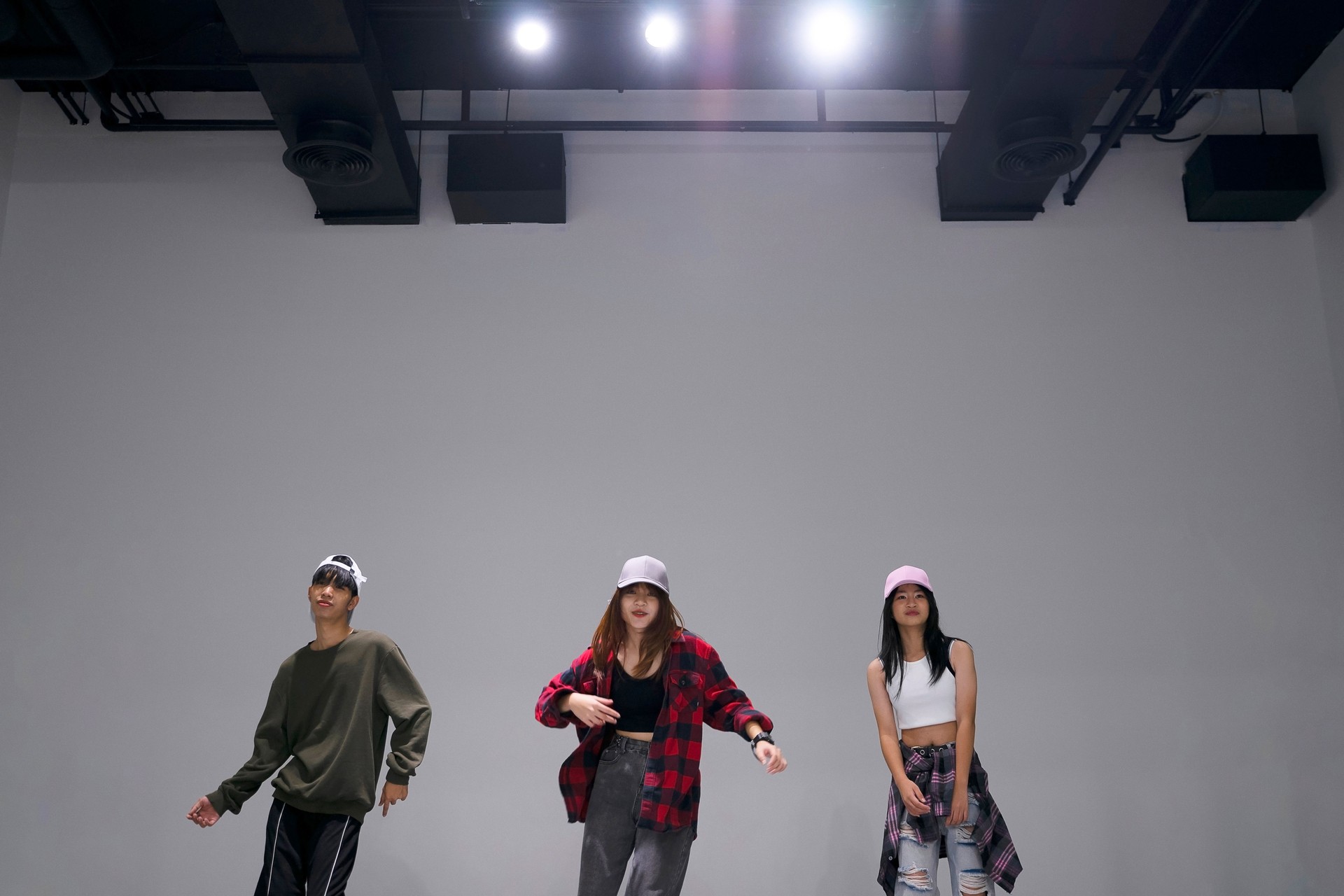 Teenage group practice of dance at studio.